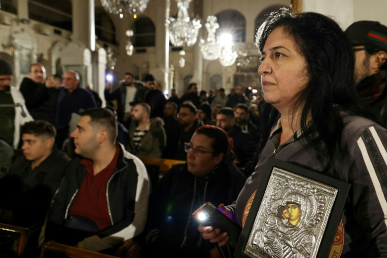 Des fidèles chrétiens rassemblés dans une église à Damas, le 24 décembre 2024 en Syrie ( AFP / ANWAR AMRO )